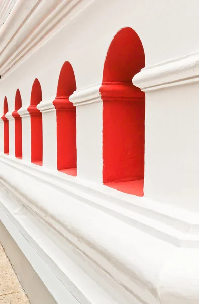 stock image White walls, red window