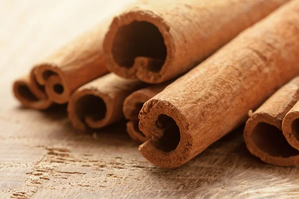 stock image Cinnamon bark on the wood surface