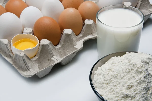 Eggs, glass of milk and flour — Stock Photo, Image