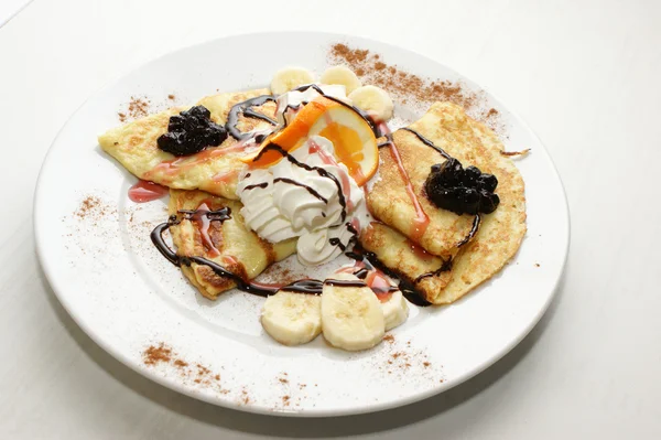 Pancakes with cheese, cream, banana, chocolate... — Stok fotoğraf