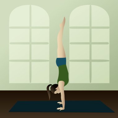 Young woman practicing yoga Adho Mukha Vrksasana clipart