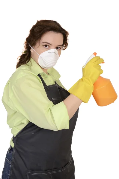 De vrouw met een sproeier in een hand en een gasmasker (2) Stockfoto