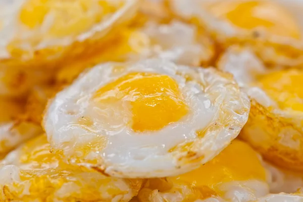 Stack of fried eggs focus on the center egg yolk — Stock Photo, Image