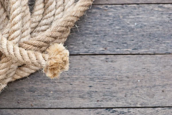 stock image Big navy rope on wooden plank
