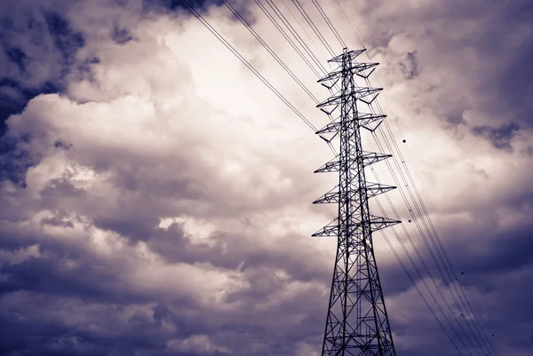 High power electrical pole on a cloudy day with silhouette — Stock Photo, Image