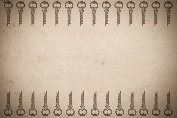 Іржаві ключі на старому паперовому фоні — стокове фото