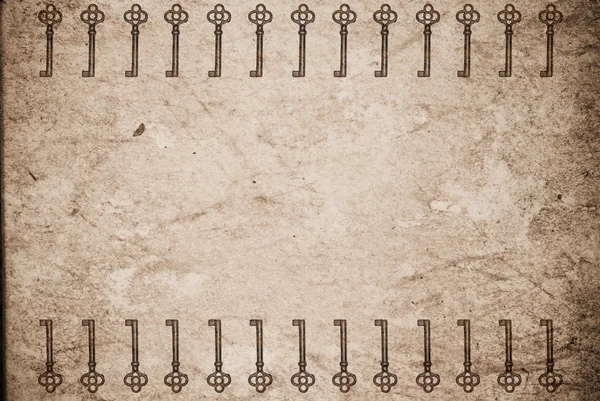 Rostige Schlüssel auf altem Papierhintergrund — Stockfoto