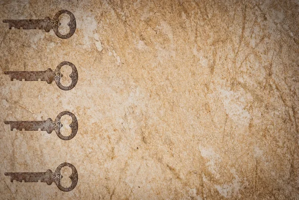 Rostiga nycklar på gamla papper bakgrund — Stockfoto