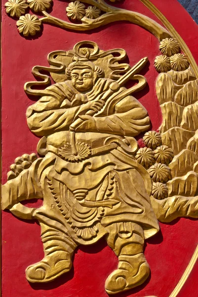 Chinese golden wall art work on red wood — Stock Photo, Image