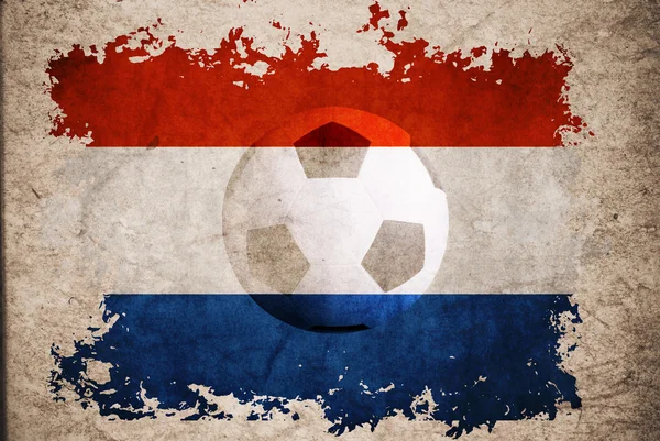 Países Baixos rasgar bandeira com fundo de futebol — Fotografia de Stock