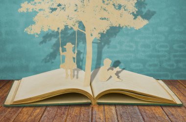 Paper cut of children read a book and children on swing under tr
