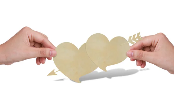 Mãos com dois corações de papel e seta — Fotografia de Stock