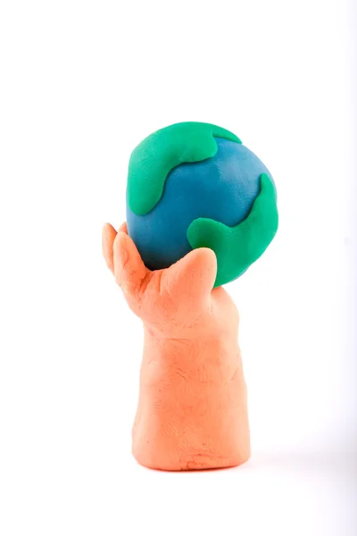 Plasticina de mão segurando a Terra — Fotografia de Stock