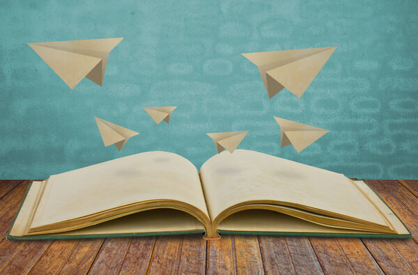 Magic book with paper plane