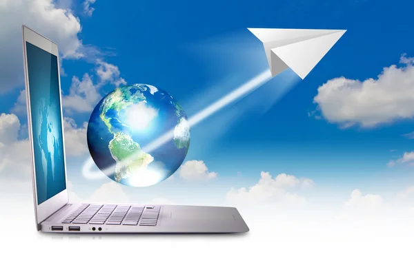 Laptop in sky with earth and paper plane — Stock Photo, Image