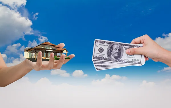 Hand exchange House with Dollar over blue sky — Stock Photo, Image