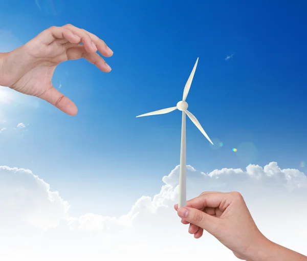 Hand holding Wind Turbine over blue sky — Stock Photo, Image