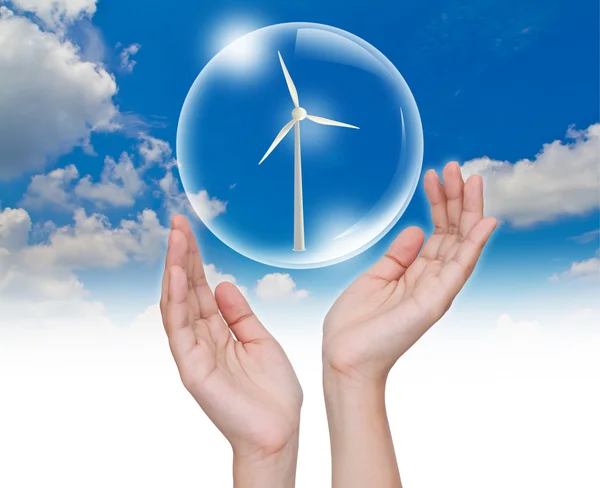 Hand holding bubble with Wind Turbine inside over blue sky — Stock Photo, Image