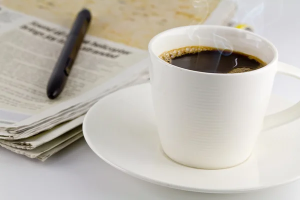 Une tasse de café et un journal — Photo