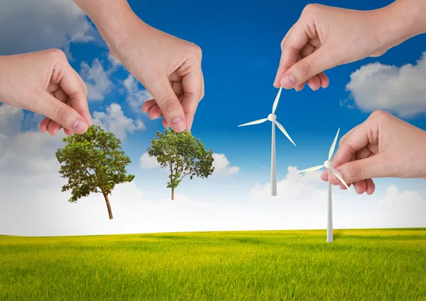 Hand hold wind turbine and tree over blue sky — Stock Photo, Image