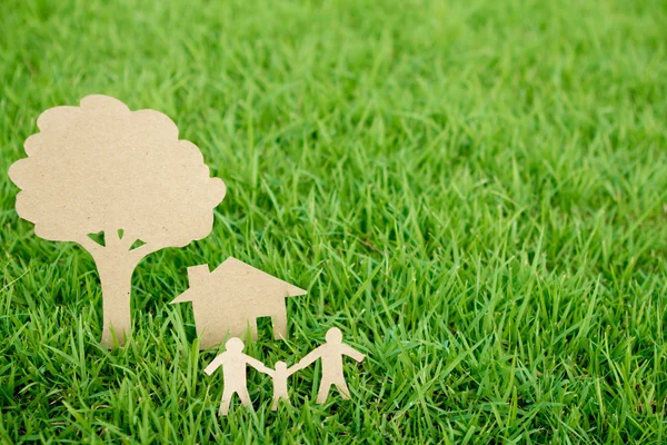 Paper cut of family with house and tree on fresh spring green gr — Stock Photo, Image