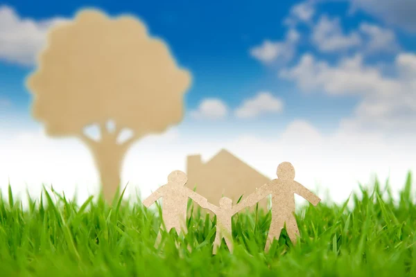 Paper cut of family with house and tree on fresh spring green gr — Stock Photo, Image
