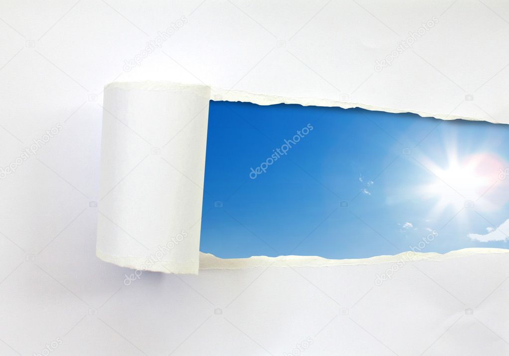 Ripped paper and blue sky