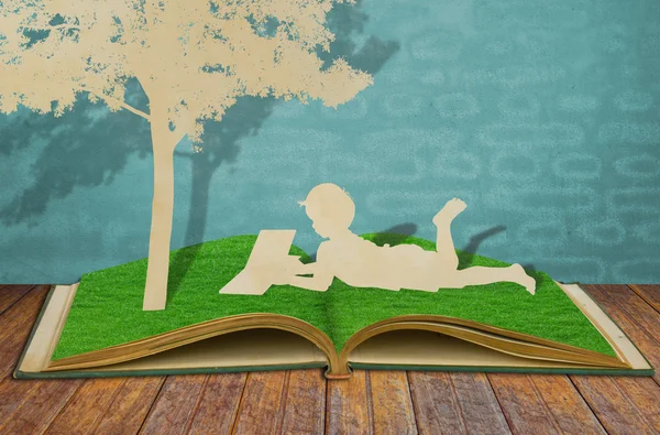 Paper cut of children read a book under tree on old book — Stock Photo, Image