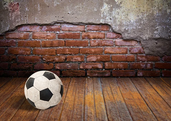 Soccer ball in the old brick room — Stock Photo, Image