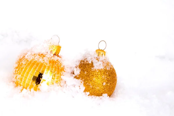 Gold christmas balls with snow — Stock Photo, Image