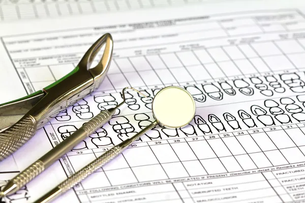 stock image Dental tools and equipment on dental chart