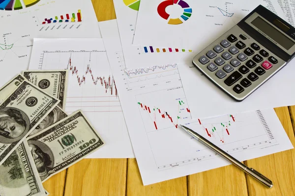 Pen ,calculator and dollars on financial Graphs — Stock Photo, Image