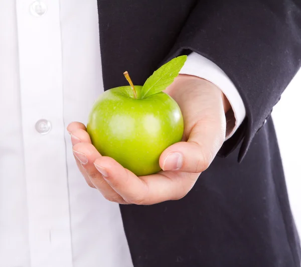 Biznesmen ręcznie z zielonym jabłkiem w dłoni izolować na biały — Zdjęcie stockowe