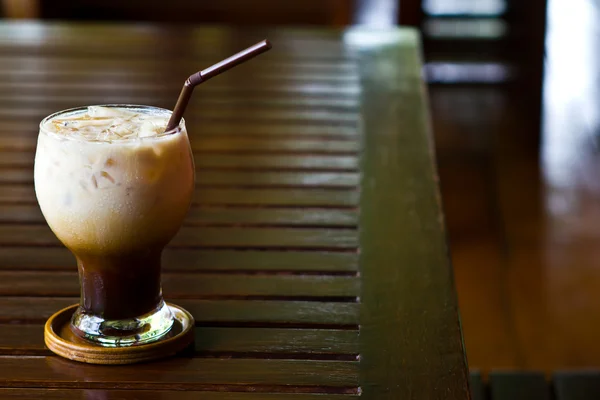 Ice cold coffee on a wooden table — Stock Photo, Image