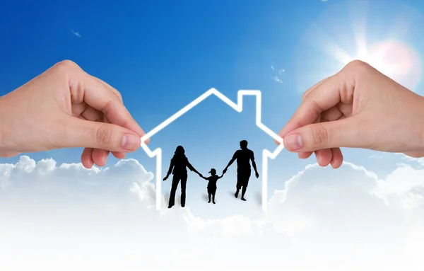 Hand with the silhouettes of the family and house — Stock Photo, Image