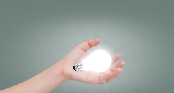 Women hand with lamp bulb — Stock Photo, Image