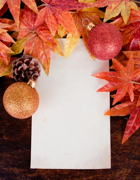 Christmas decoration and old paper with Artificial maple leafs o — Stock Photo, Image