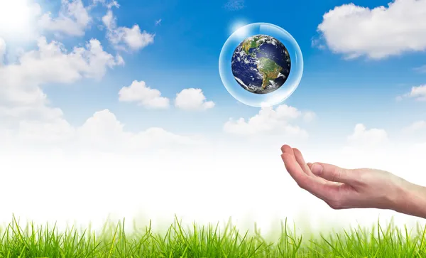 Eco concept : Hand hold globe in bubbles against the sun and the Stock Photo