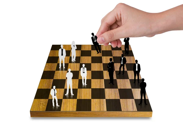 Jeu d'échecs main jeu avec des silhouettes d'affaires — Photo