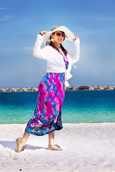Beautiful fashion asian girl playing water in Maldive beach near