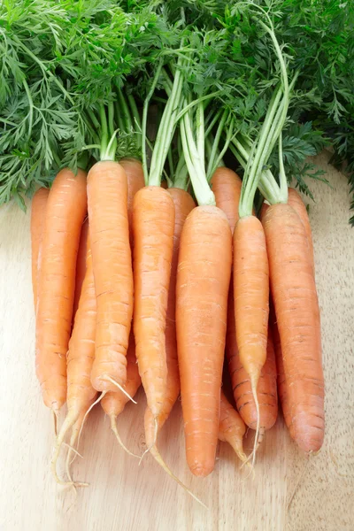 Fresh carrots on cutting board — Stock Photo, Image