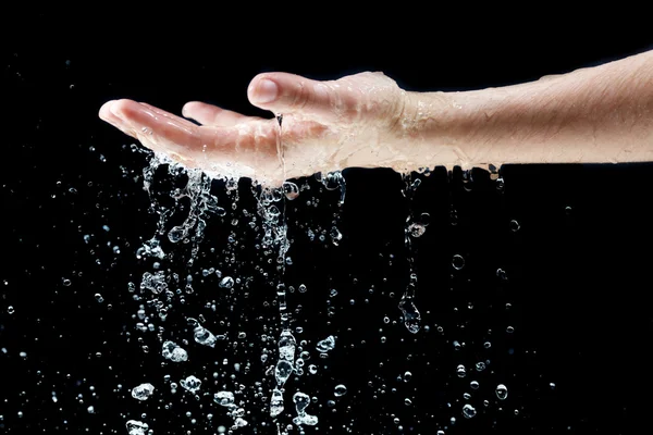 Water falling on hand — Stock Photo, Image