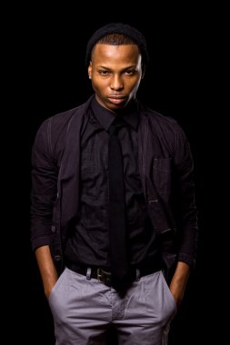 Fashionable young man. Studio shot over black. clipart