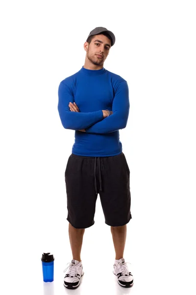 Спортсмен у синій компресійній сорочці з пляшкою води. Студійний знімок завершено — стокове фото