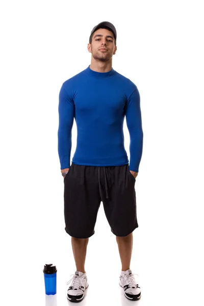 Atletische man in blauwe compressie shirt met water fles. studio opname over — Stockfoto