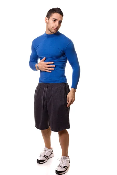 Спортивний молодий чоловік у синій компресійній сорочці. Студійний знімок над білим . — стокове фото