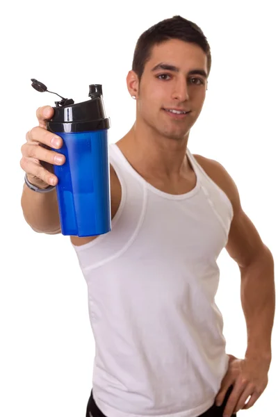 Athletic man with water bottle. Focus on bottle. Studio shot over white. — Stock Photo, Image