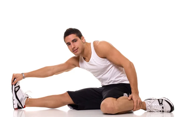 Sitting hamstring stretch. Studio shot over white. Stock Picture
