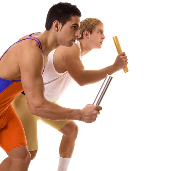 Track and field athletes competing in a relay race. Studio shot over white. — Stock Photo, Image