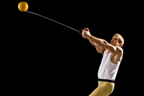 Athlete competing in hammer throw. Studio shot over black. — Stock Photo, Image
